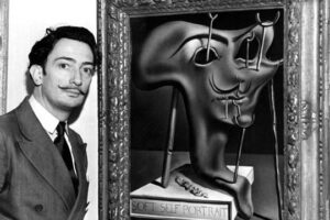 Salvador Dali showing off his piece entitled ‘Soft Self Portrait at the Julien Levy Gallery in New York 1941 e1709579251377
