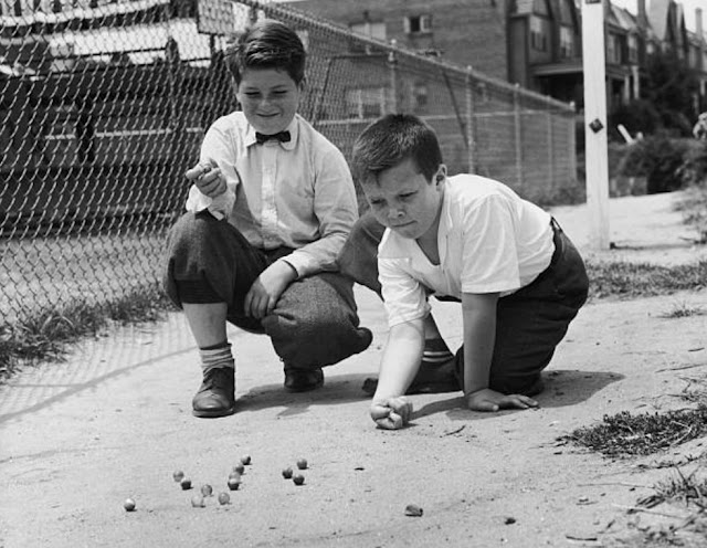 Two boys playing marbles 1955
