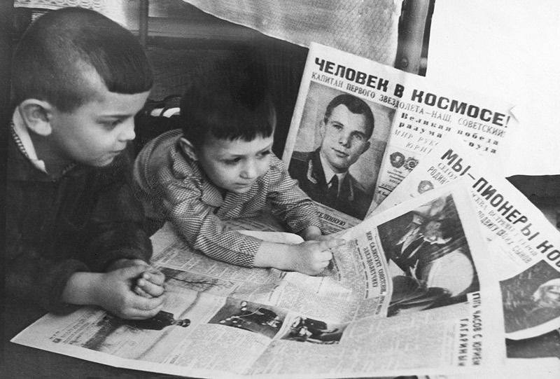 Boys looking at newspapers about Yuri Gagarins historic space flight April 13 1961