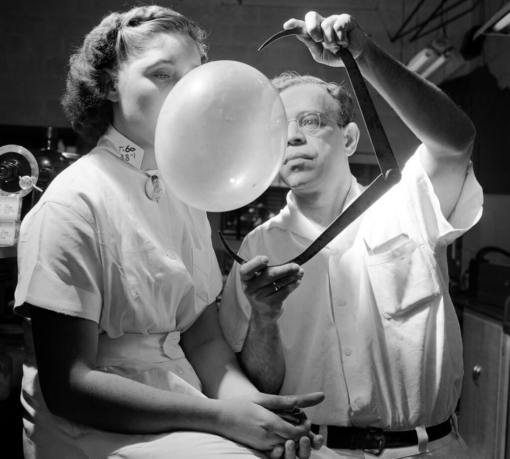 Frank Speck a professor of anthropology at the University of Pennsylvania demonstrates a bubble gum bubble in a laboratory setting in 1940