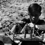 David “Chim” Seymour     Boy with Handmade Toy in the Ruins of the War Ravaged City, Vienna     1948