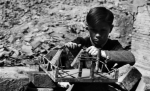 David “Chim” Seymour     Boy with Handmade Toy in the Ruins of the War Ravaged City, Vienna     1948