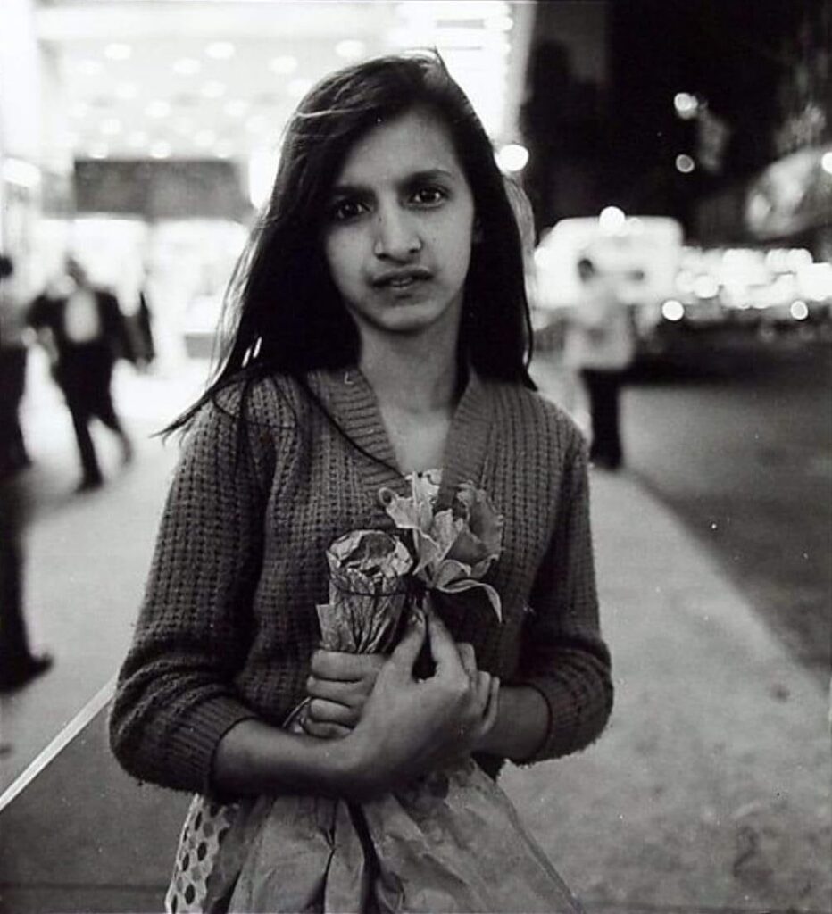 Diane Arbus Child selling plastic orchids at night NYC 1963