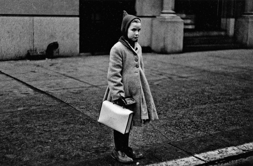 Diane Arbus Girl with a pointy hood and white schoolbag at the curb N.Y.C. 1957 1